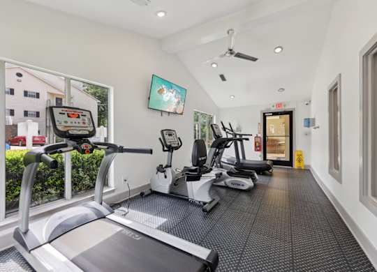 A fitness center with treadmills and ellipticals at Gwinnett Square Apartments in Duluth, GA