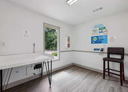 A laundry room with a folding counter at Gwinnett Square Apartments in Duluth, GA