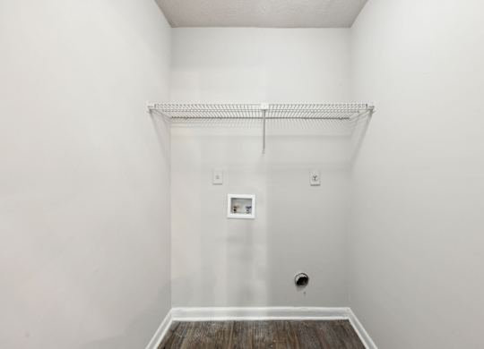 A closet with a shelf and clothes rod at Gwinnett Square Apartments in Duluth, GA