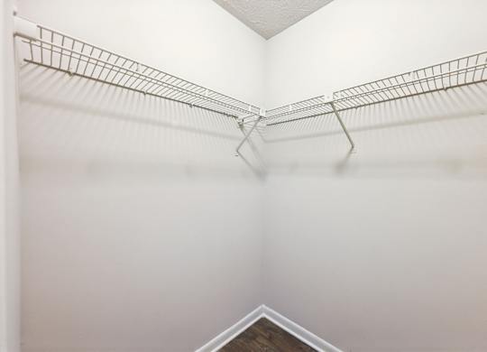 A closets with shelves and clothes rods at Gwinnett Square Apartments in Duluth, GA
