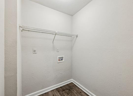 A closet with a metal shelf and clothes rod at Gwinnett Square Apartments in Duluth, GA