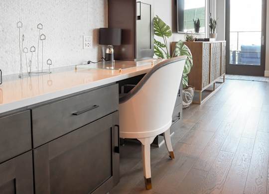 3-bedroom model built-in workspace with chair and lamp at The Hamilton apartments in Dallas, TX