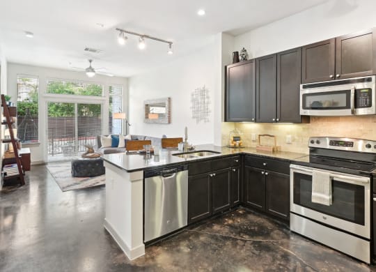 Model kitchen with stainless steel appliances at Harlow River Oaks in Houston, TX