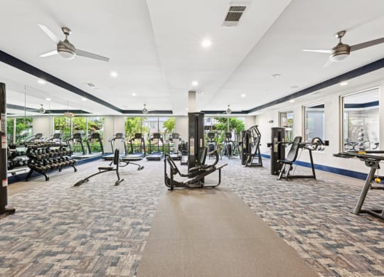 Bright fitness studio with floor-to-ceiling mirrors at Harlow River Oaks apartments in Houston, TX.