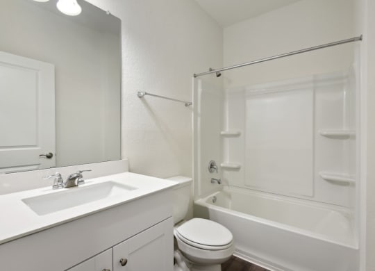 a bathroom with a sink toilet and bathtub