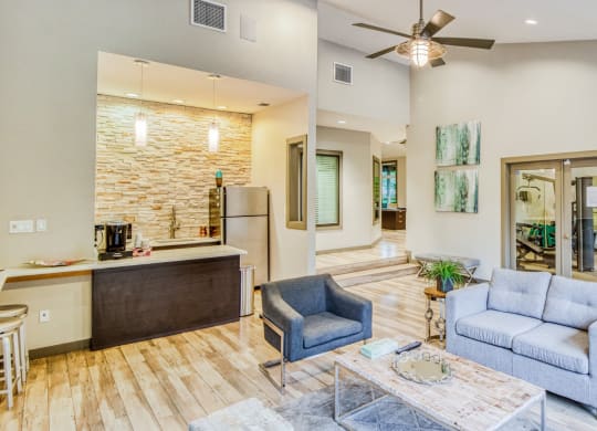 Lounge area and clubhouse kitchen space with coffee maker and fridge at Hillside Creek Apartments in Austin, TX