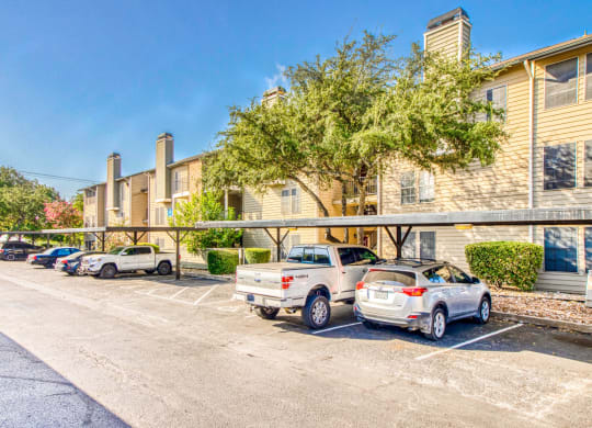 Carport spaces and apartment exteriors at Hillside Creek Apartments in Austin, TX