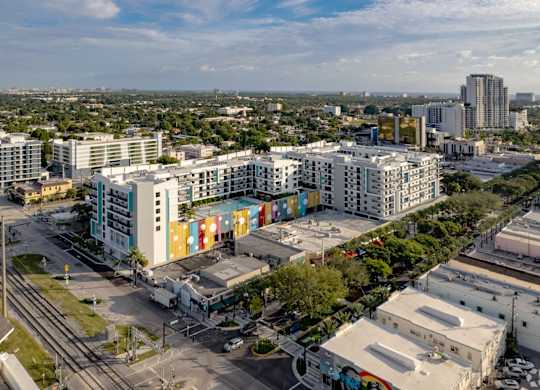 Aerial view of our rooftop patio with a colorful and vibrant mural and swimming pool at Hollywood Heights on the Boulevard Luxury Apartments in Hollywood, FL