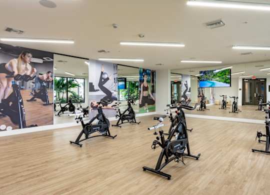Our spin room with exercise bikes and a mirror wall at Hollywood Heights on the Boulevard Luxury Apartments in Hollywood, FL.