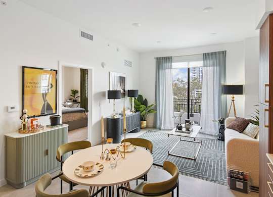 A modern dining room with a round table and chairs at Hollywood Heights on the Boulevard Luxury Apartments in Hollywood, FL
