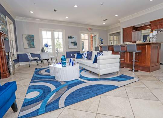 Resident lounge with couch and kitchen at Ultris Island Park in Shreveport, LA