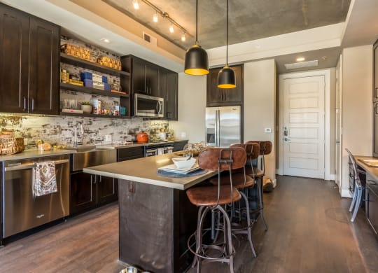 Rustic-modern interior of large kitchen setup with island at The Case Building in Dallas, TX