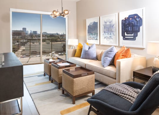 model living room with couch and a big window at Knox Heights in Dallas, TX