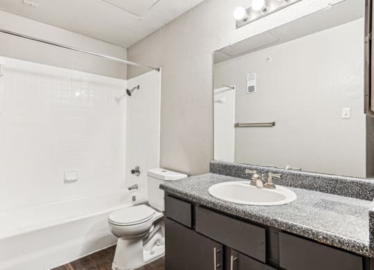 Well-appointed bathroom with shower/tub combo at Laurels of Sendera apartments in Arlington, TX