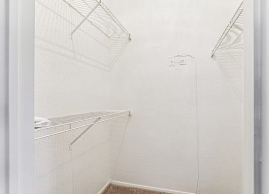Walk-in closet with ample storage space at Laurels of Sendera apartments in Arlington, TX