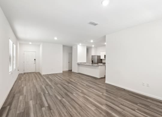 the living room and kitchen with hardwood floor