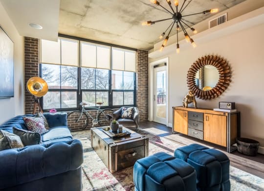 Large living room of apartment with posh decorations at The Case Building in Dallas, TX