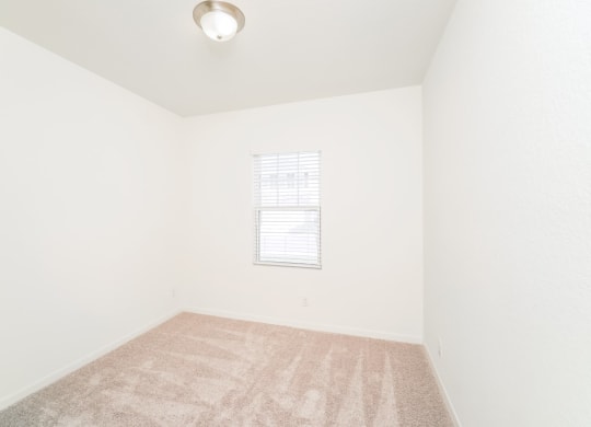 a bedroom with white walls and carpet at Beacon at Bunton Creek, Texas