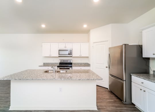 a kitchen with white cabinets and a granite counter top at Beacon at Bunton Creek, Kyle, TX 78640