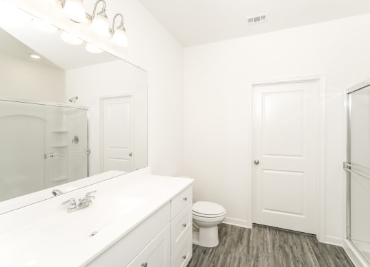 Magnolia master bathroom with stand-up shower, white counters and cabinets, at Beacon at Ashley River Landing in Summerville, SC