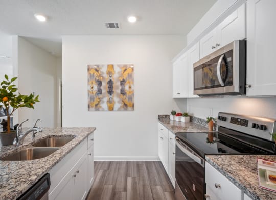 Maple kitchen with island and stainless steel appliances at Beacon at Ashley River Landing in Summerville, SC