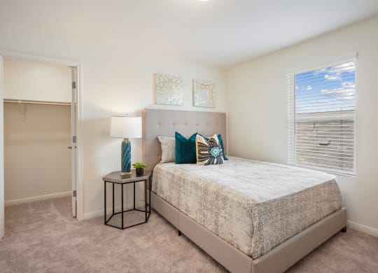 Maple model bedroom with a bed and a window at Beacon at Ashley River Landing in Summerville, SC