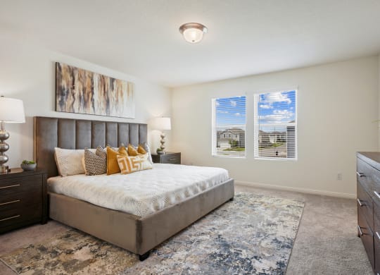 Maple master bedroom with two windows at Beacon at Ashley River Landing in Summerville, SC