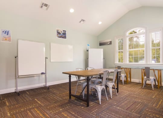 Spacious and well-equipped meeting area with a large table and chairs at Angel Landing apartments in Pensacola, FL