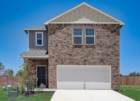 a home with a white garage door at Beacon at Meridian, San Antonio