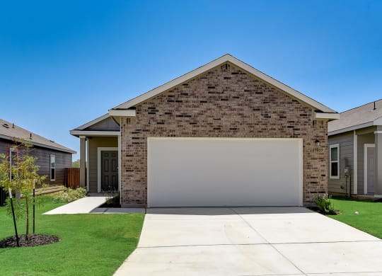 a home with a white garage door at Beacon at Meridian, Texas