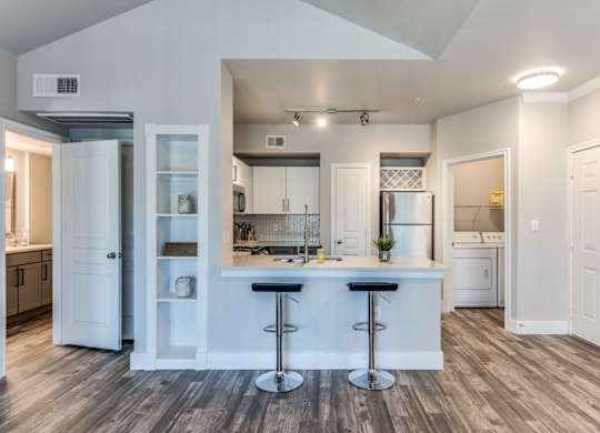 A2 model kitchen and dining area with stainless steel appliances at Asheville at Spring Branch apartments in Houston, TX