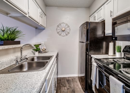 Model Kitchen with Upgraded Black Appliances at The Park on Preston in Dallas, Texas, TX