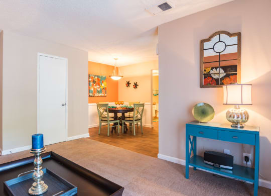 a living room with a blue cabinet and a dining room table at Dunwoody Pointe in Sandy Springs, GA