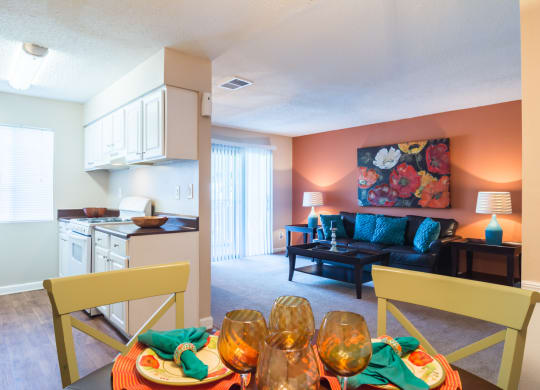 a living room with a dining room table and a kitchen at Dunwoody Pointe in Sandy Springs, GA