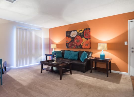 a living room with a couch and a table at Dunwoody Pointe in Sandy Springs, GA