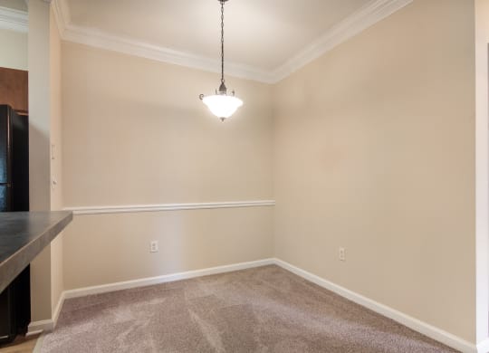 Model apartment dining area beside the kitchen at Angel Landing Apartment Homes in Pensacola, FL
