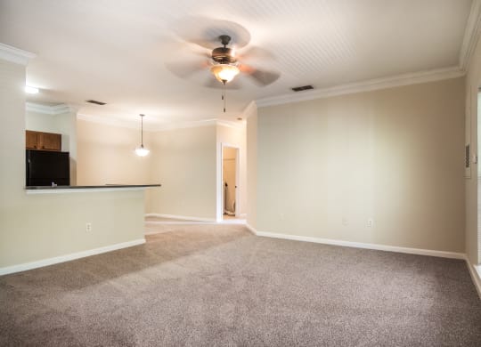Spacious empty living room with carpeted floor at Angel Landing apartments in Pensacola, FL