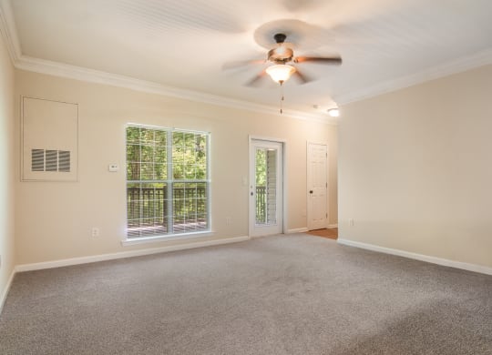Cozy living room featuring carpeted flooring at Angel Landing apartments in Pensacola, FL