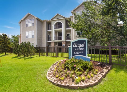 Monument entrance sign welcoming residents and visitors at Angel Landing apartments in Pensacola, FL