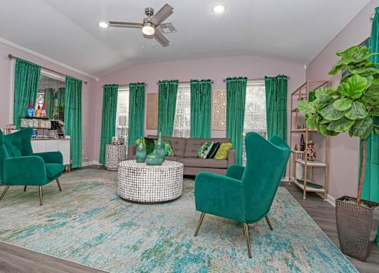 Clubhouse with green chairs and a coffee counter at The Marq in Shreveport, LA