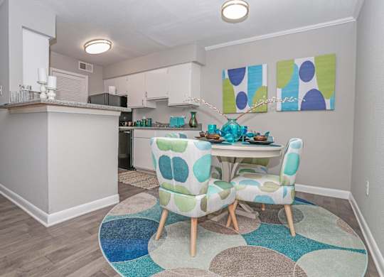 A cypress dining room with a table and chairs in the middle of the room at The Marq in Shreveport, LA