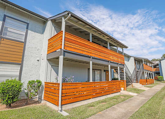 Exterior view of our apartment patio and balconies with beautiful wood fencing at The Marq apartments in Shreveport, LA