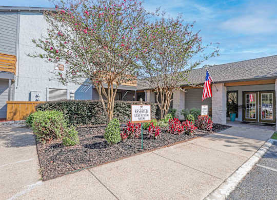 Entrance to our leasing office with a US flag at The Marq apartments in Shreveport, LA