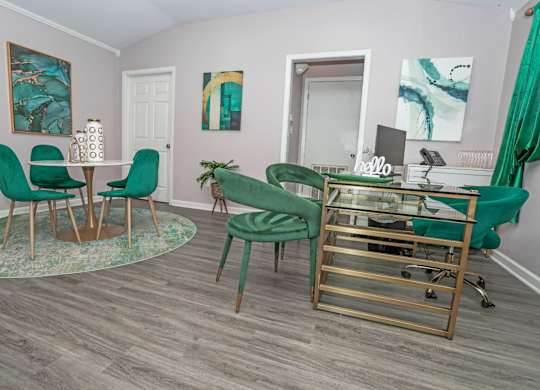 Leasing office interior with chairs and a glass desk at The Marq apartments in Shreveport, LA
