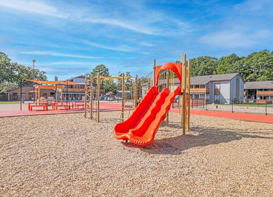 A playground with a red slide at The Marq apartments in Shreveport, LA
