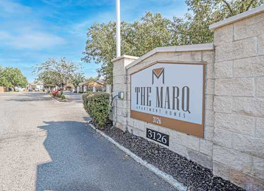 The Marq Apartment Homes sign is on a stone wall at The Marq apartments in Shreveport, LA
