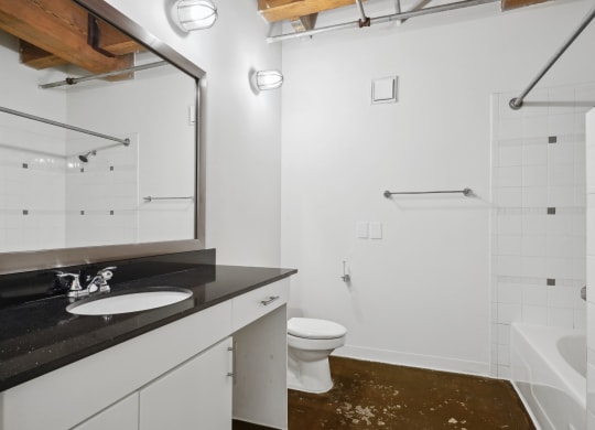 Murray loft spacious bathroom modern vanity and shower | Deep Ellum Lofts in Dallas, TX
