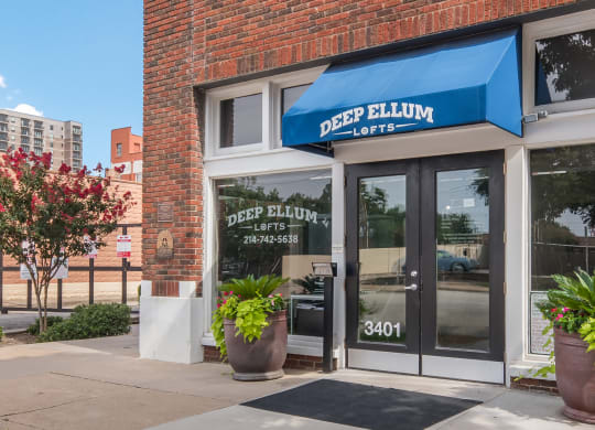 a blue awning over a door with glass windows and a window sign that reads deep