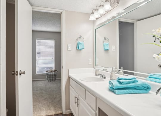 Model A2 floor plan bathroom with a sink and a mirror Noel on The Parkway in Dallas, TX