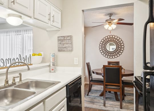 Model A2 floor plan kitchen and dining room with a sink and a ceiling fan at Noel on the Parkway in Dallas, TX